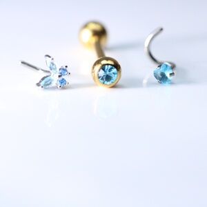 Set of 3 items Two Nose Piercings and one golden barbell New